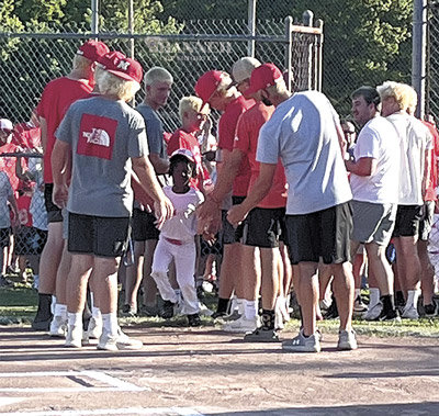 The McKenzie Rebel Baseball Team joined the ceremony, high-fiving each player when his name was announced.