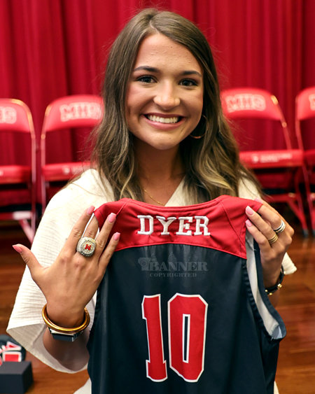 Dani Dyer, the lone senior player, displays her championship ring and a souvenir jersey.