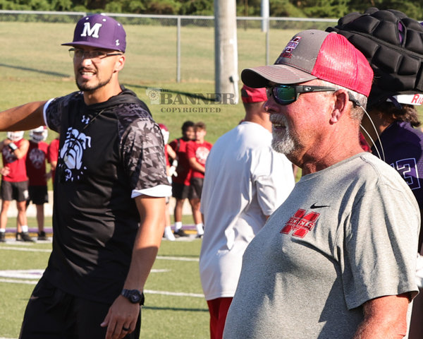 Milan head coach Derek Carr (left) and McKenzie head coach Wade Comer as their teams participate in 7 on 7 at Bethel’s Wildcat Stadium. Coach Carr was the quarterback for the McKenzie Rebels under Comer’s leadership.