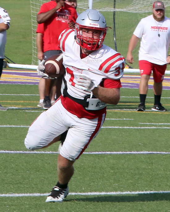 McKenzie’s Ty Anderson turns upfield for yards during scrimmage action.