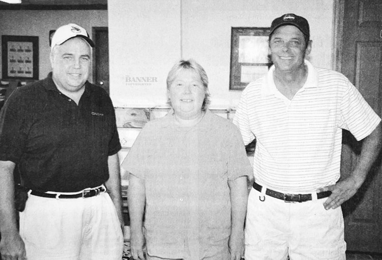 Monte Cunningham (left) poses with the new owners of the Carroll Lake Golf Course Nan and Jerry Stanley.