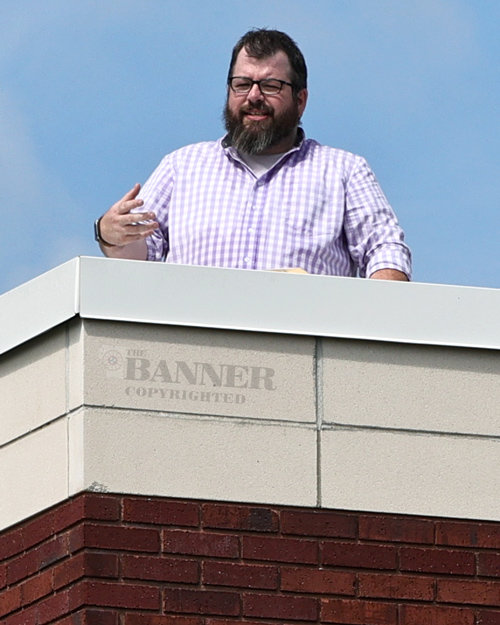 Reverend Rob Harris preaches from the rooftop of the First Cumberland Presbyterian Church.