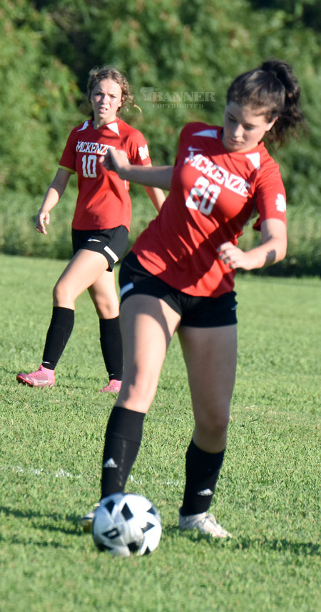 Laken Fisher (20) works the ball against the Lady Lions.