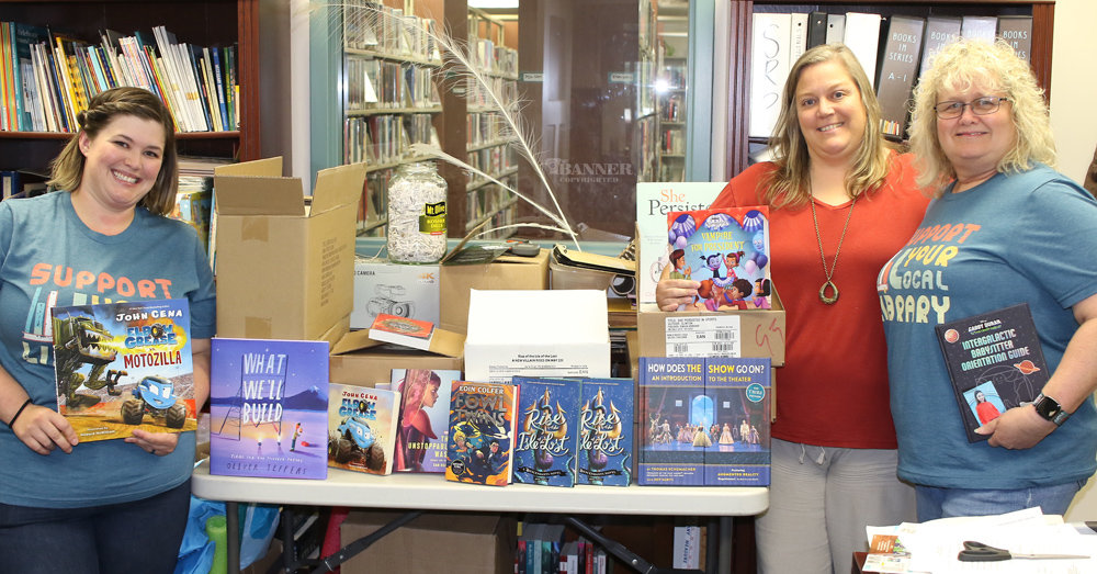 Books Donated to Carl Perkins Center for the Prevention of Child Abuse — Erin Crockett, librarian, and Denise Coleman (pictured right) donate 665 new books to Tee-Jay Glidwell, director of the Carl Perkins Center in Carroll County. The books will be given to child clients of the Center. Books will be distributed during counseling sessions and at Christmas.