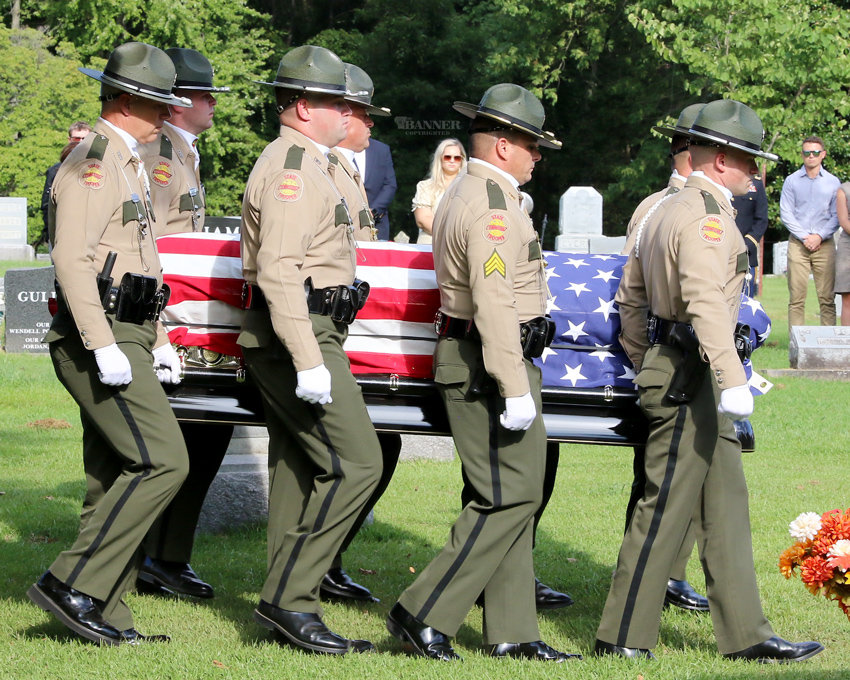 Pallbearers carry Sergeant Russell’s casket to the grave site.