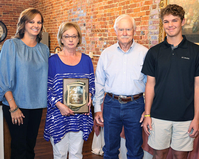Marsha Mash retired from Carroll County Electric Department on August 31. She was employed from 1989 to 2022. She was presented a plaque by Ryan Drewry, General Manager. Pictured are family members Sandy Fronabarger, Brody, Marsha and husband, Gene.