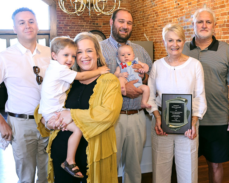 Hilda Wallace retired from Carroll County Electric Department as the longest serving employee. She started in 1973 and retired in 2022. She was presented a plaque from Ryan Drewry, General Manager. Pictured are Hilda and family members, Stuart, Nathan, Kelley, husband Chuck, and grandchildren Jack and Brady.