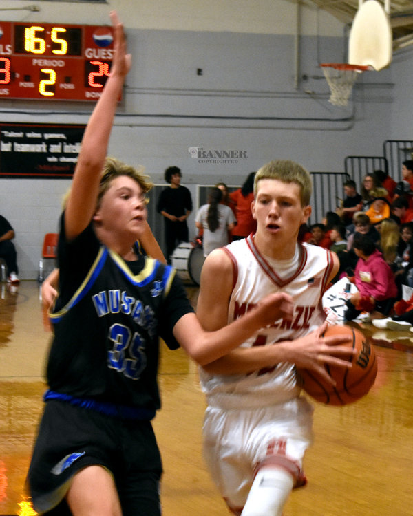 Avery Brown (42) drives to the basket guarded by Greyson Anderson (35).