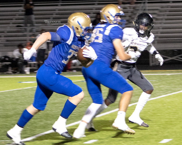 Silas Sharp (32) follows his blocker for yards against Mitchell.