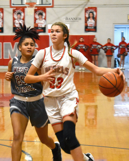Jaycee Stafford (23) drives past West Carroll’s Airyonna Metcalf for a shot.