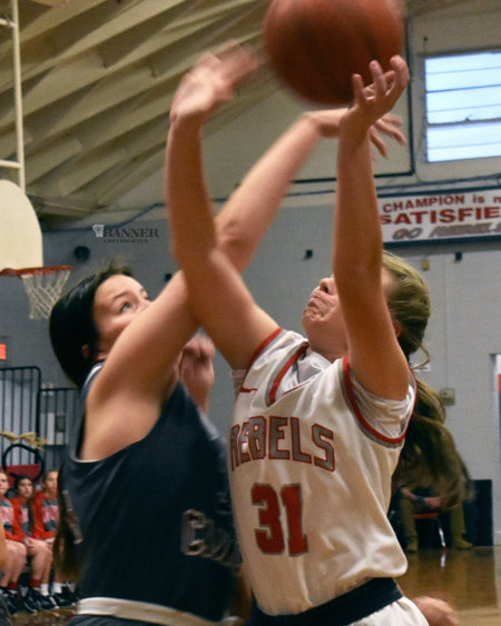 Aurora Johnson (31) fights for a rebound against the Lady War Eagles.