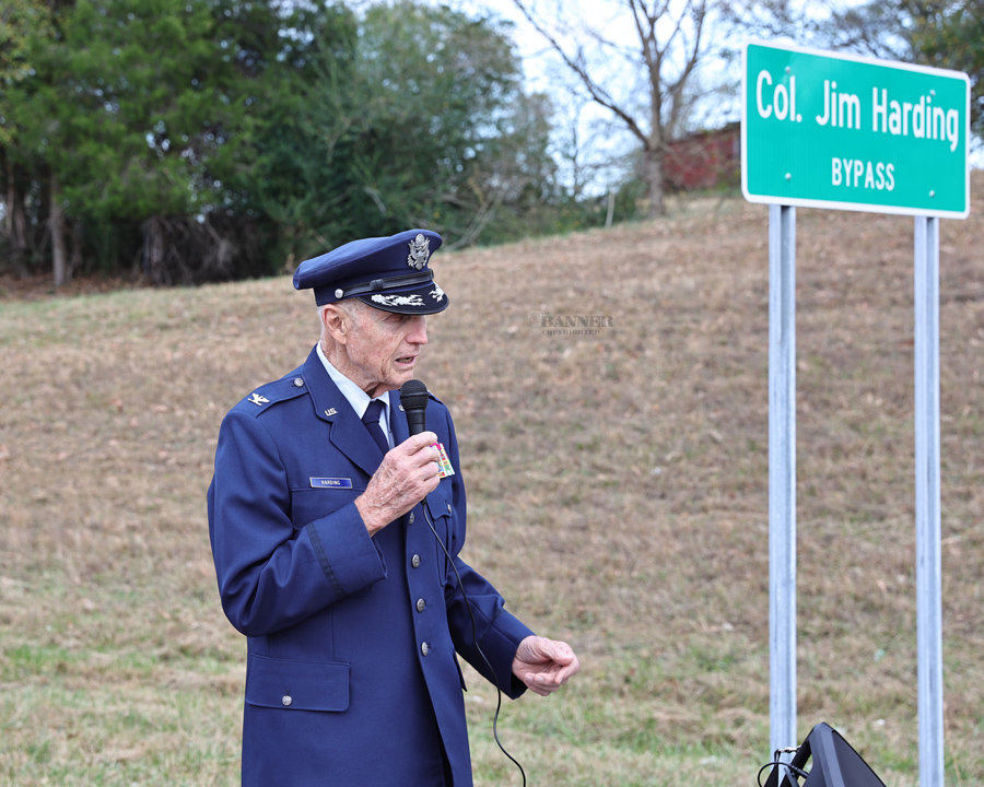 Colonel James Harding looks at the new sign erected in his honor.