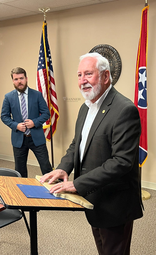Representative Curtis Halford (right) addresses members of the Carroll County Commission following the presentation of a plaque and proclamation from County Mayor Joseph Butler (left).