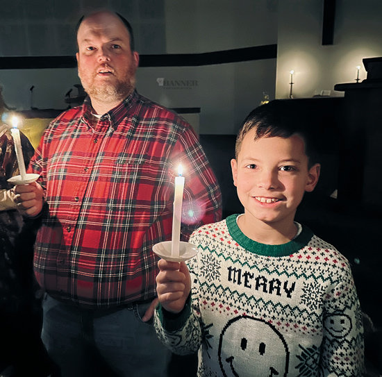 Stephen and Jack Brown participated in the annual Christmas Eve Candlelight Service at the First Cumberland Presbyterian Church-McKenzie. Church attendees, holding lighted candles, lined around the interior wall of the sanctuary to celebrate the birth of Christ.