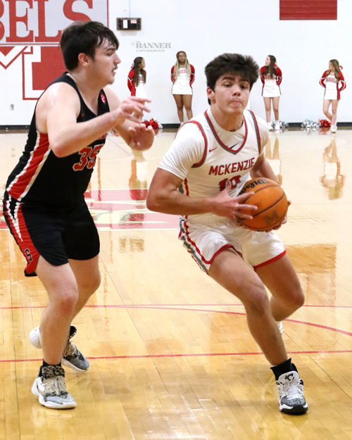 McKenzie’s Tate Surber drives toward the basket as Big Sandy’s Cole Pierpoint defends.