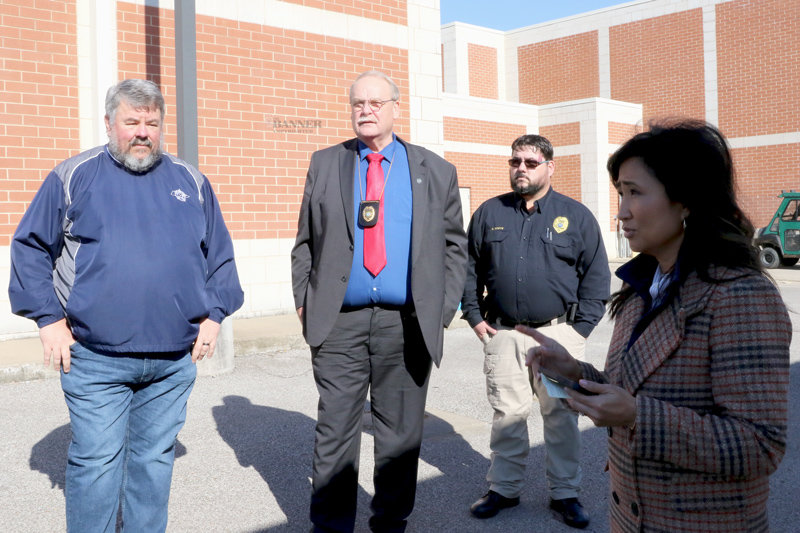 Keli McAlister with the Tennessee Bureau of Investigation speaks to reporters as Carroll County Sheriff Andy Dickson, Public Safety Director Walter Smothers, and McKenzie Chief Ryan White await their turn to speak to reporters.