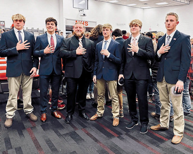 Displaying their championship rings are: Craegen Travis, Tate Surber, Coach Dylan Benson, Jake Cassidy, Drew Chappell and Jackson Cassidy.
