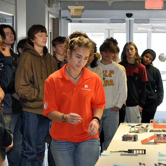 Ariel Young shows McKenzie High School students the components of the storage devices developed by Cachengo.
