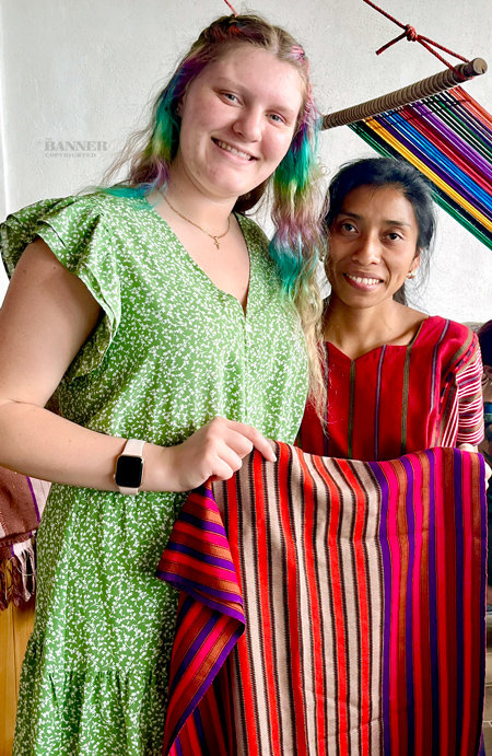 Jacey McClure of Dresden displays a handmade clothing item made by a Mayan master weaver of the Kaqchikel people.