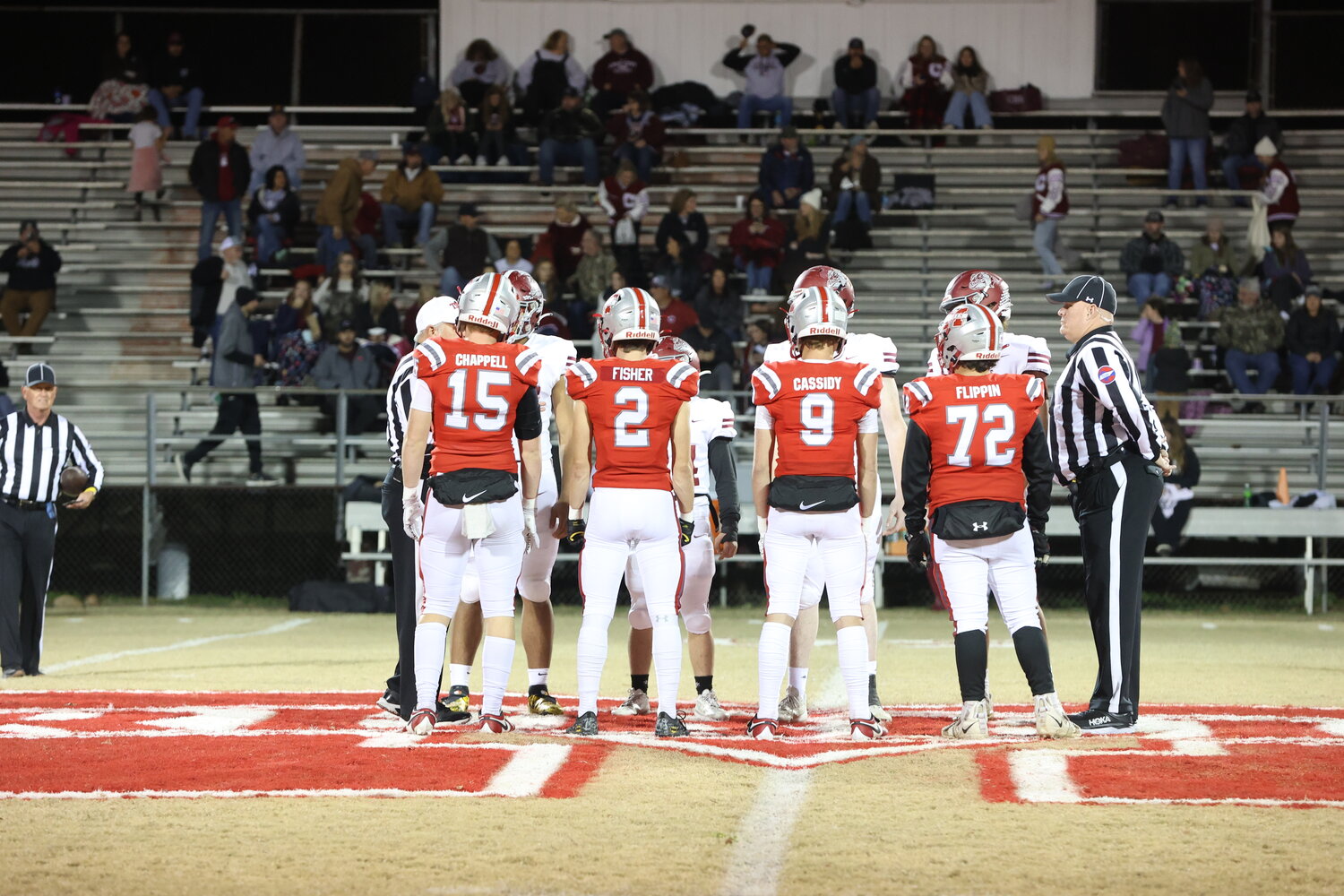 Team captains for the Rebels at the coin toss.