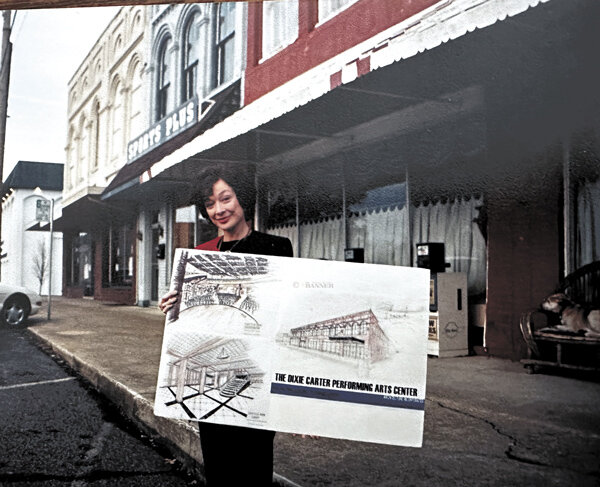 The late actress, Dixie Carter-Holbrook, holds an architectural rendering of the then proposed Dixie Carter Performing Arts Center. Behind her are the buildings that once stood where the beautiful performing arts center now stands in downtown Huntingdon. It opened in 2005.