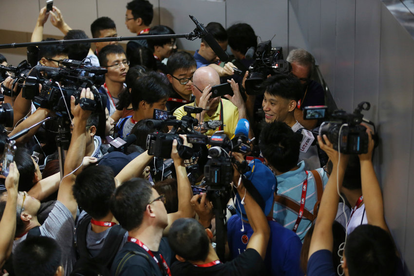 In this Oct. 10, 2015, file photo, NBA basketball player Jeremy Lin of the Charlotte Hornets talks to media after a training session for the 2015 NBA Global Games in Shenzhen, China. As sports prepare to resume, journalists are facing the same reckoning that their colleagues who cover politics, education and entertainment have encountered &mdash; coming up with new approaches to coverage with reduced access and resources. Professional leagues closed media access to locker rooms and clubhouses in early March. (AP Photo/Kin Cheung, File)