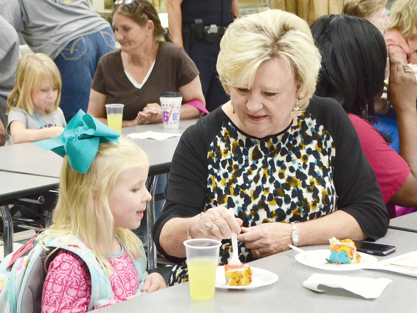 Betty Odom is retiring to spend more time with her grandchildren. Odom is pictured having lunch with one of her children at a Grandparents Day celebration at T.R. Simmons.
