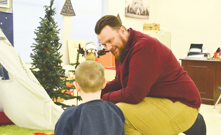 Behavioral interventionist Anthony Sellers works with a student at Sumiton Elementary School.