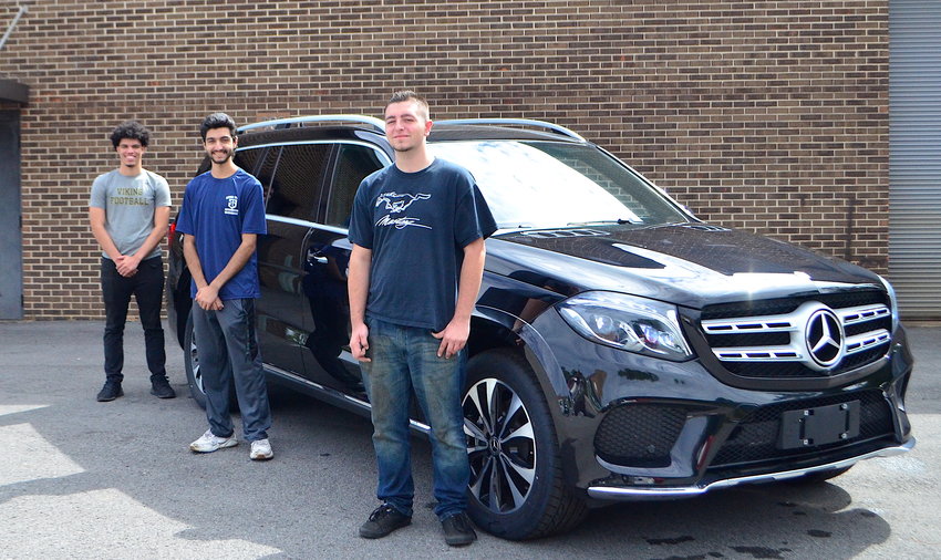 Bevill State Community College-Sumiton students, from left to right, Jacob Danner, Daniel Fazli and Donnie Sexton are pictured with an SUV that Mercedes-Benz recently donated to the college. The three students are currently participating in the Mercedes-Benz Tech Co-Op Program, a partnership between the college and Mercedes.
