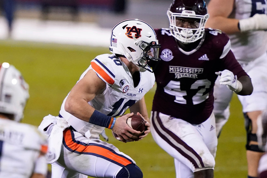 Auburn quarterback Bo Nix (10) is pursued by Mississippi State defensive end Marquiss Spencer (42) during the second half of Saturday's game in Starkville, Miss. Auburn won 24-10.