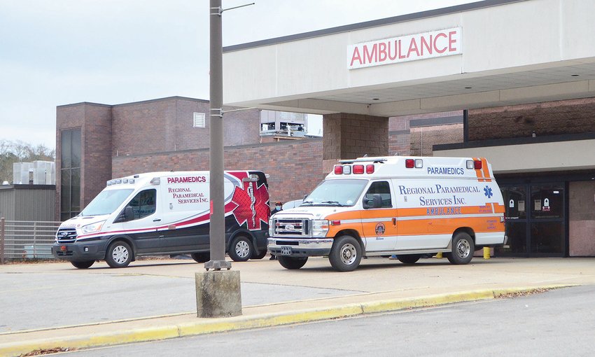 Employees with RPS are spending hours at hospitals in Alabama waiting on rooms for patients, which is causing delayed EMS response times. Two ambulances are pictured outside of Walker Baptist Medical Center on Monday.