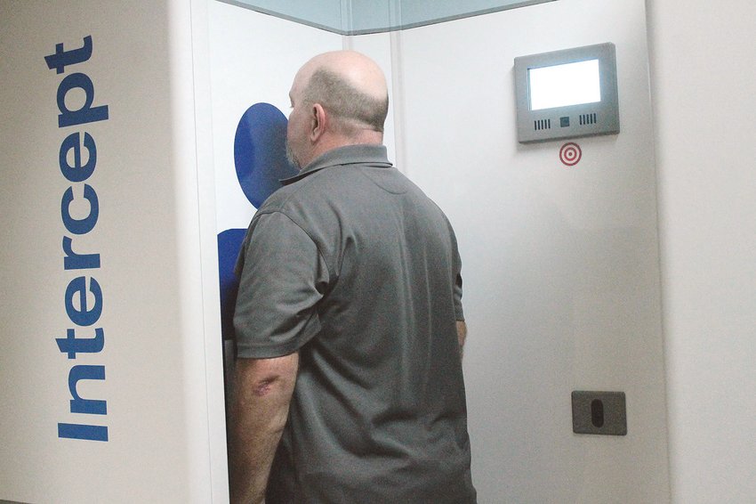 A technician demonstrates how to use the full body scanner acquired for the Walker County Jail with CARES Act funding.