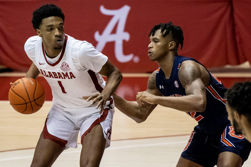 Alabama's Herb Jones (1) works inside against Auburn guard Allen Flanigan (22) during the second half of their game Tuesday in Tuscaloosa.