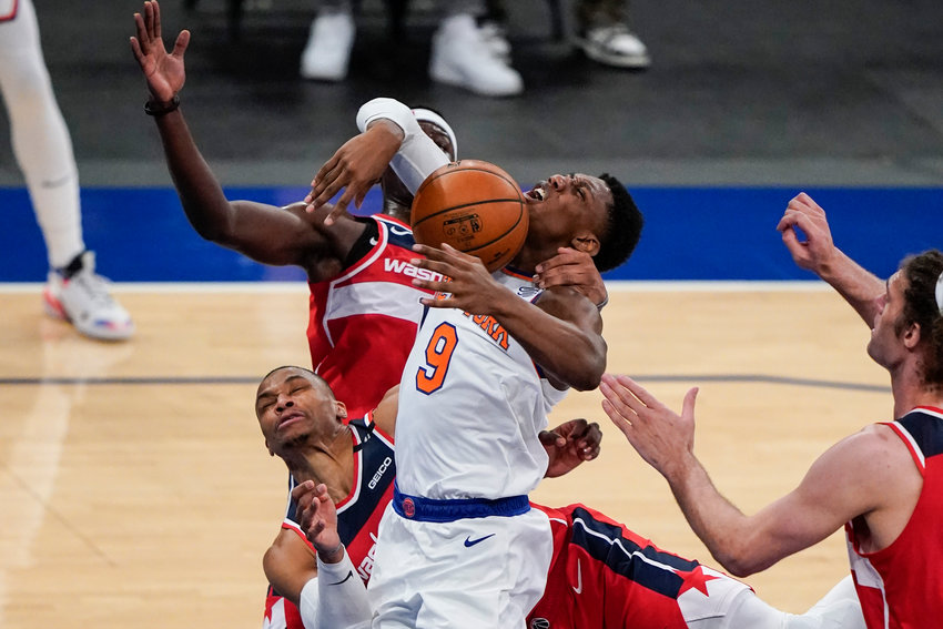 New York Knicks' RJ Barrett (9) is fouled by Washington Wizards' Russell Westbrook, left, and Isaac Bonga during the second half of an NBA basketball game Thursday, March 25, 2021, in New York. The Knicks won 106-102. (AP Photo/Frank Franklin II, Pool)