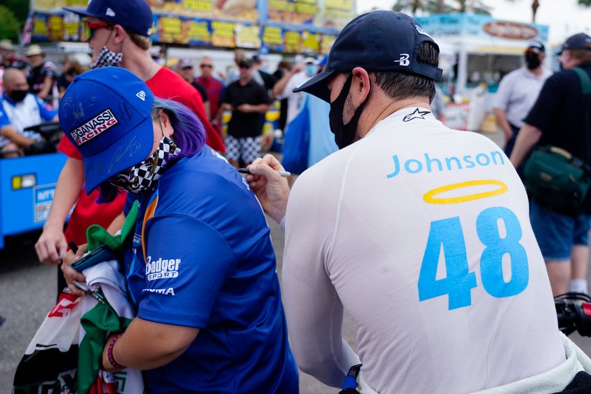 IndyCar driver #48 Jimmie Johnson signs the shirt of fan Caroline Gast of Sarasota after the morning practice session at the Grand Prix of St. Petersburg, on Sunday, April 25, 2021 in St. Petersburg.