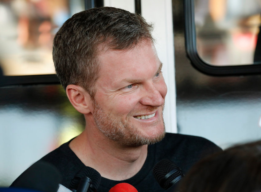 FILE - Dale Earnhardt Jr. talks with the media in the garage area before practice for a NASCAR auto race in Darlington, S.C., in this Friday, Aug. 30, 2019, file photo. He&rsquo;s a 46-year-old married father of two daughters, a NASCAR Hall of Fame inductee and the 15-time fan-voted most popular driver. No matter all his personal bliss, Earnhardt still has social anxieties and was a wreck when NBC Sports launched its NASCAR coverage at Nashville with a heavily-promoted pre-race show that featured him alongside country star Brad Paisley.  &ldquo;I was terrified,&rdquo; Earnhardt told The Associated Press of the assignment. (AP Photo/Terry Renna, File)
