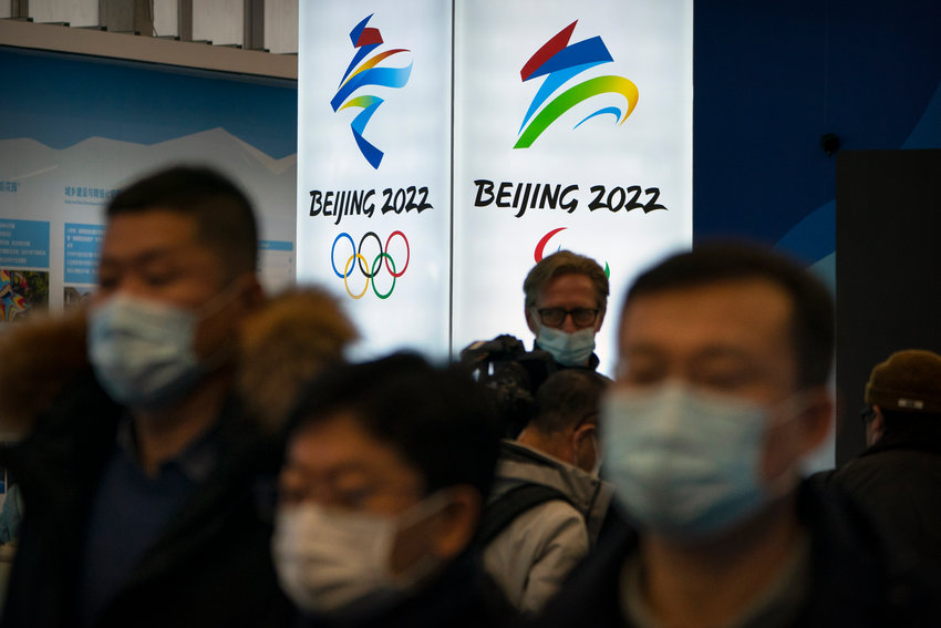 FILE - In this Feb. 5, 2021, file photo, attendees wearing face masks to protect against the spread of the coronavirus look at an exhibit at a visitors center at the Winter Olympic venues in Yanqing on the outskirts of Beijing. The IOC says the Olympics are only about the sports; no politics allowed. But reporters from other countries who puncture the PR skin to explore other aspects of life in China &mdash; as they have in Japan during the Tokyo Olympics &mdash; could draw more than criticism. (AP Photo/Mark Schiefelbein, File)