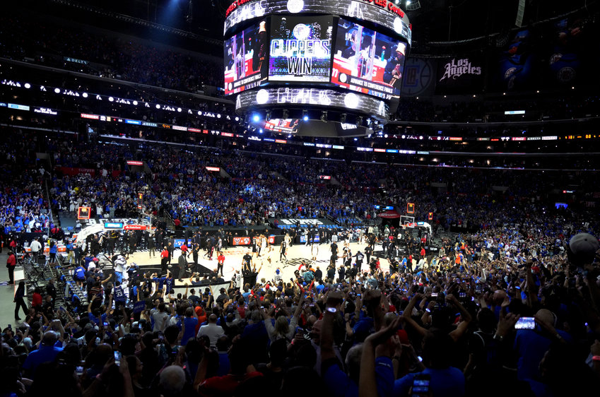 FILE - In this June 18, 2021, file photo, Los Angeles Clippers fans cheer in the final moments of the Clippers' 131-119 win over the Utah Jazz in Game 6 of the second-round of the Western Conference the NBA basketball playoffs. California will tighten its rules for indoor events starting Sept. 20, 2021, requiring either proof of vaccination or a negative coronavirus test for gatherings of 1,000 people or more as new virus cases continue to climb because of the delta variant. (Keith Birmingham/The Orange County Register via AP, File)