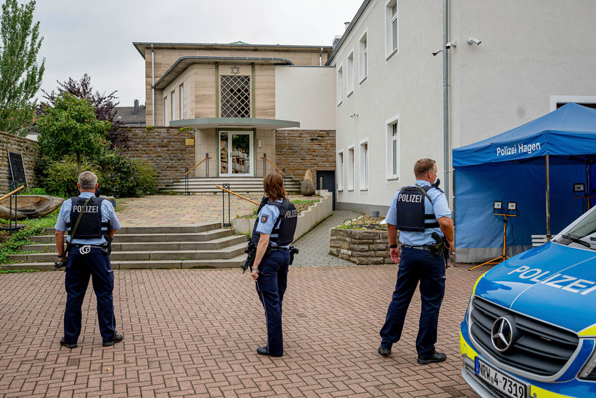 Police officers stay in front of the entrance to the Jewish Community building in Hagen, Germany, Tursday, Sept. 16, 2021. Numerous police officers protected the synagogue in the night, the police spoke of indications of a possible dangerous situation. (Henning Kaiser/dpa via AP)