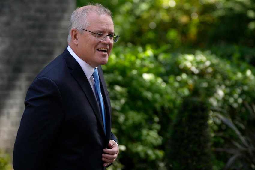 Australia's Prime Minister Scott Morrison leaves after meeting with Britain's Prime Minister Boris Johnson at 10 Downing Street, in London, Tuesday, June 15, 2021. Britain and Australia have agreed on a free trade deal that will be released later Tuesday, Australian Trade Minister Dan Tehan said. (AP Photo/Matt Dunham)