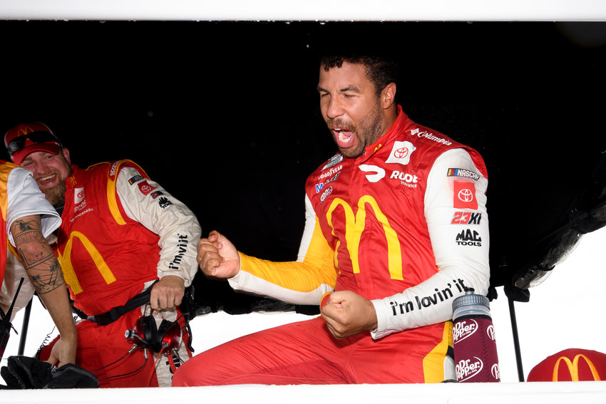 Bubba Wallace reacts after he is pronounced the winner while waiting out a rain delay before which he was the leader during a NASCAR Cup series auto race Monday, Oct. 4, 2021, in Talladega, Ala. (AP Photo/John Amis)