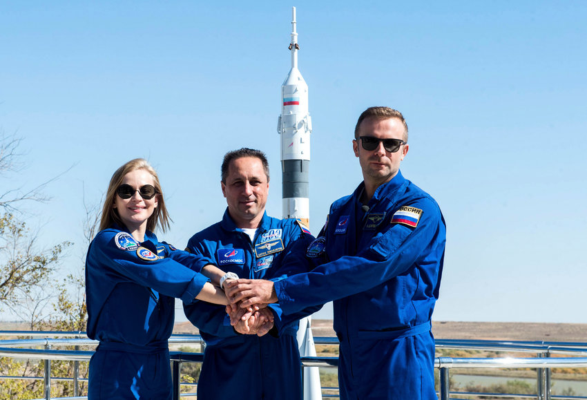 In this handout photo released by Roscosmos, Actress Yulia Peresild, left, director Klim Shipenko' right, and cosmonaut Anton Shkaplerov, members of the prime crew of Soyuz MS-19 spaceship pose at the Russian launch facility in the Baikonur Cosmodrome, Kazakhstan, Monday, Sept. 27, 2021. PIn a historic first, Russia is set to launch an actress and a film director to space to make a feature film in orbit. Actress Yulia Peresild and director Klim Shipenko are set to blast off Tuesday for the International Space Station in a Russian Soyuz spacecraft together with Anton Shkaplerov, a veteran of three space missions. (Andrey Shelepin, Roscosmos Space Agency via AP)