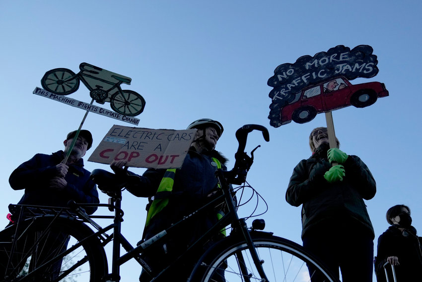People take part in a pro-cycling demonstration outside the SEC (Scottish Event Campus) venue for the COP26 U.N. Climate Summit, in Glasgow, Scotland, Wednesday, Nov. 10, 2021. The U.N. climate summit in Glasgow has entered its second week as leaders from around the world, are gathering in Scotland's biggest city, to lay out their vision for addressing the common challenge of global warming. (AP Photo/Alastair Grant)