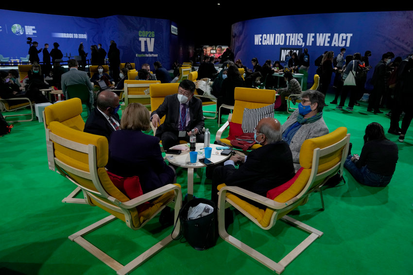 Delegates speak to each other in the Action Zone at the COP26 U.N. Climate Summit, in Glasgow, Scotland, Wednesday, Nov. 10, 2021. The U.N. climate summit in Glasgow has entered its second week as leaders from around the world, are gathering in Scotland's biggest city, to lay out their vision for addressing the common challenge of global warming. (AP Photo/Alastair Grant)
