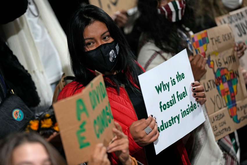 Youth climate activists protest that representatives of the fossil fuel industry have been allowed inside the venue during the COP26 U.N. Climate Summit in Glasgow, Scotland, Thursday, Nov. 11, 2021. (AP Photo/Alastair Grant)