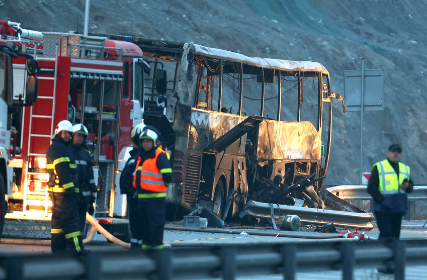 Firefighters and forensic workers walk at the scene of a bus crash which killed at least 45 people, according to authorities, on a highway near the village of Bosnek, western Bulgaria , Tuesday, Nov. 23, 2021. The bus, registered in Northern Macedonia, crashed around 2 a.m. and there were children among the victims, authorities said.&nbsp;(Minko Chernev, BTA Agency Bulgaria via AP)