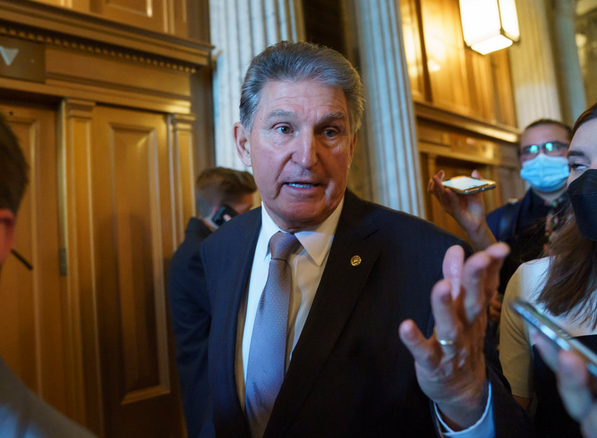 FILE - Sen. Joe Manchin, D-WVa., talks to reporters as he leaves the chamber after a vote, at the Capitol in Washington, on Nov. 3, 2021. Democrats have finally driven President Joe Biden&rsquo;s $2 trillion package of family services, health care and climate initiatives through the House. Now the focus turns to the Senate, where painful Republican amendments, restrictive rules and moderate Democratic Sen. Joe Manchin lurk (AP Photo/J. Scott Applewhite, File)