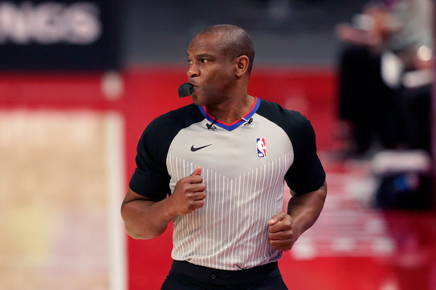 FILE - Referee Tony Brown runs on the sideline during the first half of an NBA basketball game between the Detroit Pistons and the Toronto Raptors, Wednesday, March 17, 2021, in Detroit. NBA referee Tony Brown, who was diagnosed with Stage 4 pancreatic cancer in March, says his treatment is going well and he&rsquo;s hopeful of possibly returning to the court at some point this season.(AP Photo/Carlos Osorio, File)