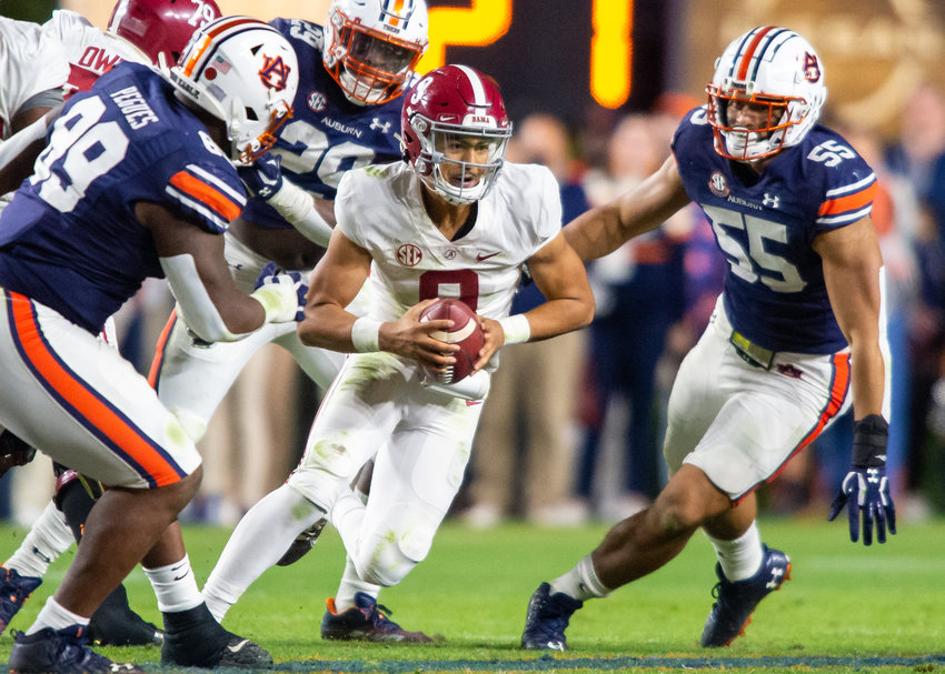 Alabama quarterback Bryce Young (9) runs against Auburn's defense during Alabama's 24-22 4OT win against the Tigers in the Iron Bowl. (Daily Mountain Eagle)
