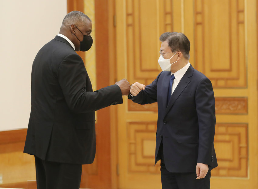 South Korean President Moon Jae-in, right, bumps elbows with U.S. Defense Secretary Lloyd Austin before their meeting at the presidential Blue House in Seoul, South Korea, Thursday, Dec. 2, 2021. Austin said Thursday that China&rsquo;s pursuit of hypersonic weapons &ldquo;increases tensions in the region&rdquo; and vowed the U.S. would maintain its capability to deter potential threats posed by China. (Ahn Jung-hwan/Yonhap via AP)